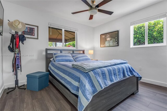 9621 SW 59th Ter, Miami, FL 33173 - bedroom featuring multiple windows, wood finished floors, baseboards, and a ceiling fan