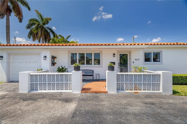 9621 SW 59th Ter, Miami, FL 33173 - mediterranean / spanish-style home with an attached garage and stucco siding