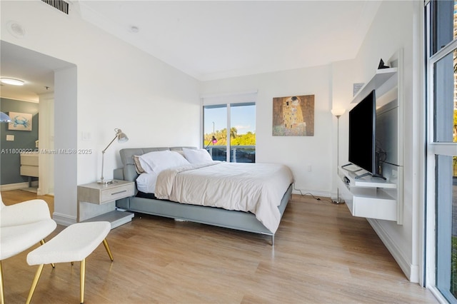20505 E Country Club Dr Unit 143, Aventura, FL 33180 - bedroom featuring light wood-style floors, baseboards, and access to exterior