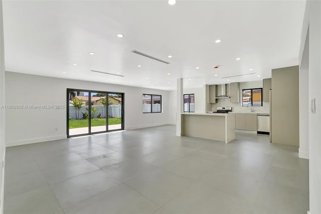 129 NE 2nd Ave, Dania Beach, FL 33004 - unfurnished living room with a sink, recessed lighting, baseboards, and light tile patterned floors