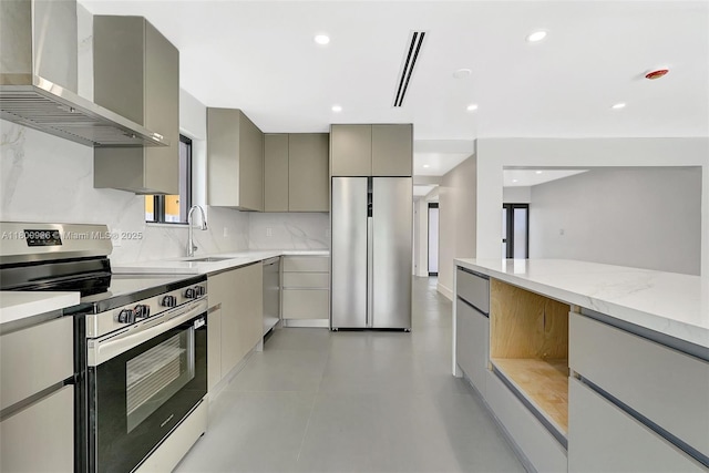 129 NE 2nd Ave, Dania Beach, FL 33004 - kitchen featuring appliances with stainless steel finishes, gray cabinetry, wall chimney exhaust hood, modern cabinets, and a sink