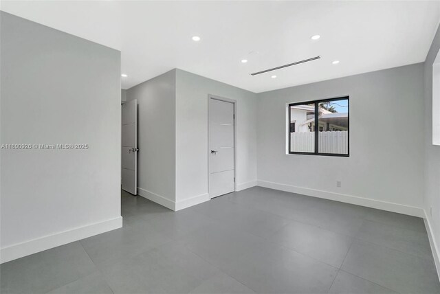 129 NE 2nd Ave, Dania Beach, FL 33004 - empty room with baseboards, recessed lighting, and finished concrete flooring