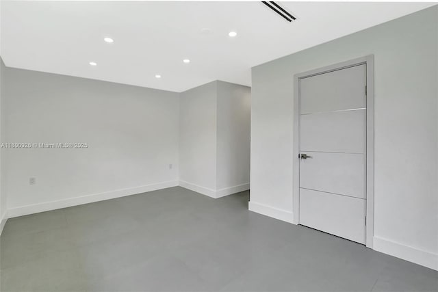 129 NE 2nd Ave, Dania Beach, FL 33004 - unfurnished bedroom with finished concrete floors, recessed lighting, baseboards, and a closet