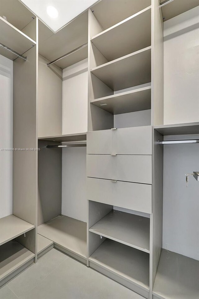 129 NE 2nd Ave, Dania Beach, FL 33004 - walk in closet with tile patterned flooring