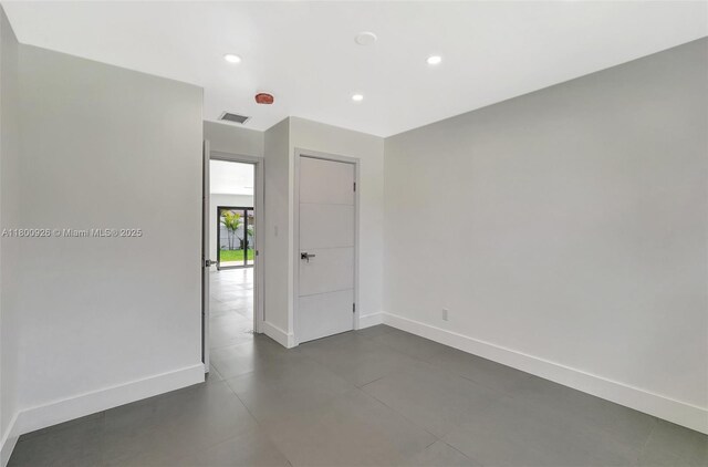 129 NE 2nd Ave, Dania Beach, FL 33004 - empty room with baseboards and recessed lighting