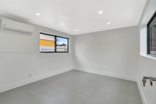 129 NE 2nd Ave, Dania Beach, FL 33004 - tiled empty room with an AC wall unit, baseboards, and recessed lighting