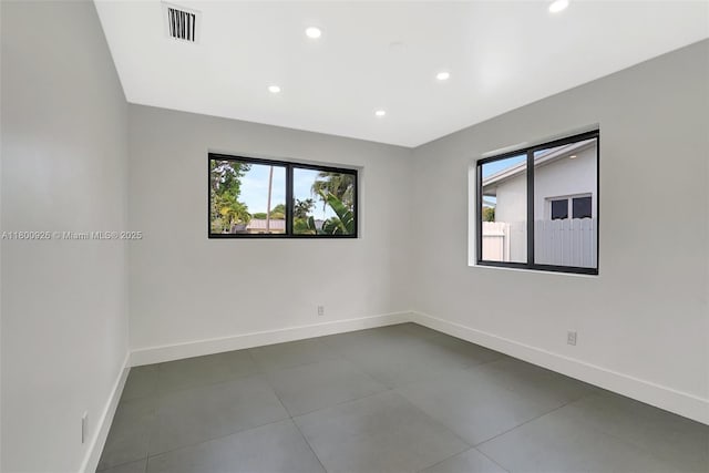 129 NE 2nd Ave, Dania Beach, FL 33004 - spare room featuring baseboards, recessed lighting, and dark tile patterned flooring