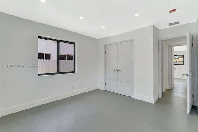 129 NE 2nd Ave, Dania Beach, FL 33004 - unfurnished bedroom featuring baseboards, recessed lighting, and a closet