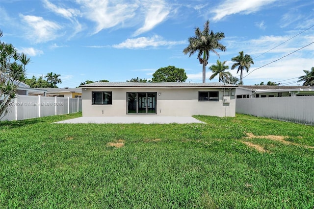 129 NE 2nd Ave, Dania Beach, FL 33004 - rear view of house with stucco siding and a patio area