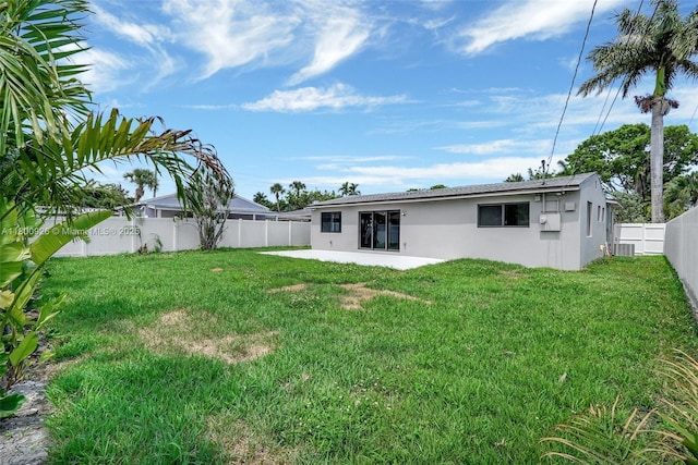 129 NE 2nd Ave, Dania Beach, FL 33004 - rear view of property with stucco siding and a patio