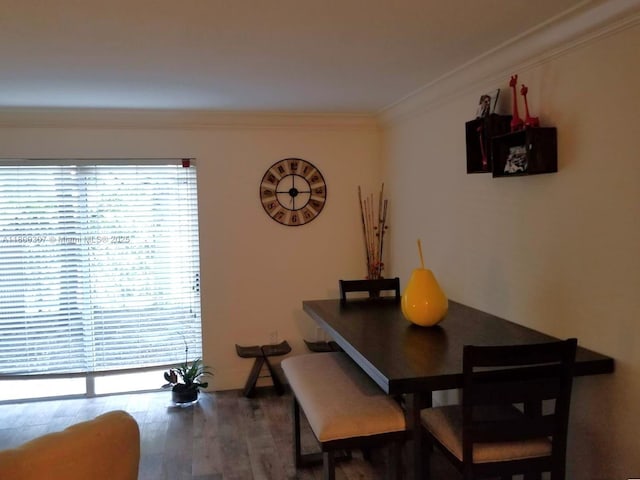 dining area featuring crown molding and wood finished floors