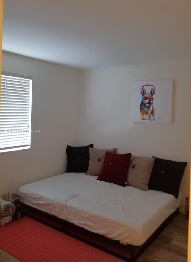 bedroom featuring wood finished floors