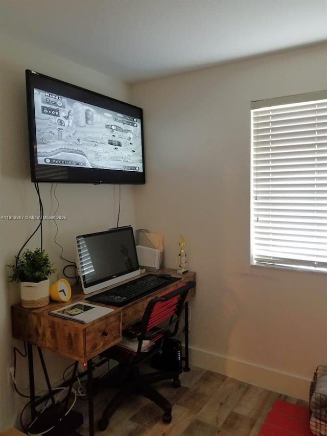 office space with wood finished floors and baseboards