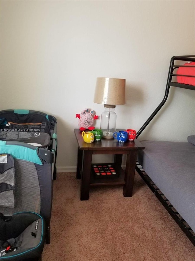 carpeted bedroom featuring baseboards