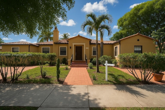 1741 SW 17th Ct, Miami, FL 33145 - mediterranean / spanish-style home with a tile roof, a front yard, and stucco siding