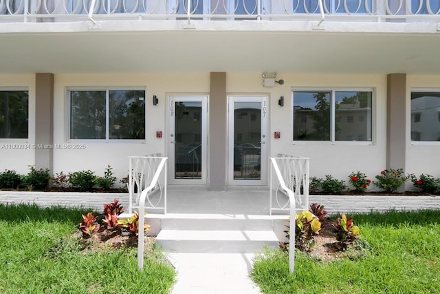 1601 Meridian Ave Unit 101, Miami Beach, FL 33139 - doorway to property with stucco siding and covered porch