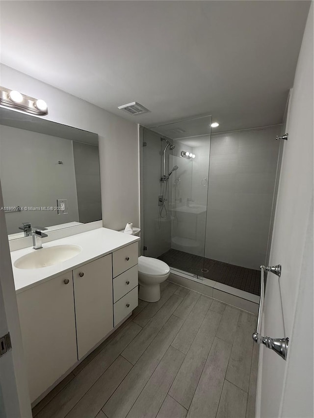 1601 Meridian Ave Unit 101, Miami Beach, FL 33139 - bathroom with wood finished floors, toilet, walk in shower, and vanity