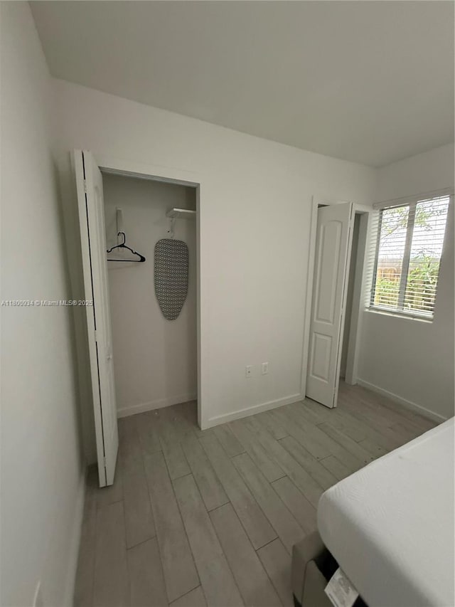 1601 Meridian Ave Unit 101, Miami Beach, FL 33139 - unfurnished bedroom with light wood-style floors and baseboards