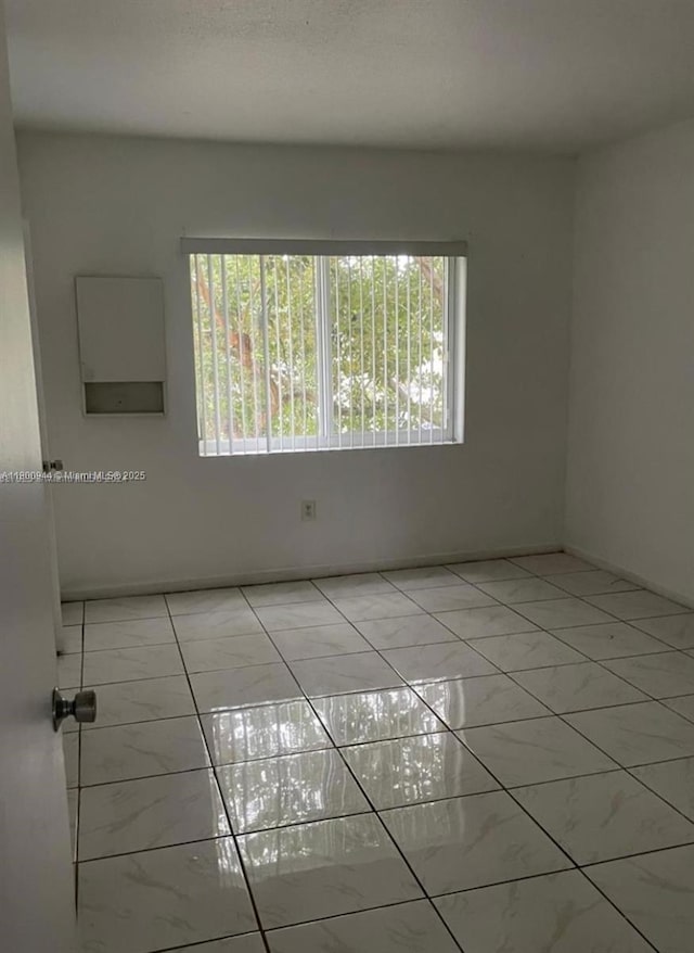 307 NW 84th St Unit 307, Miami, FL 33150 - empty room featuring light marble finish flooring and plenty of natural light
