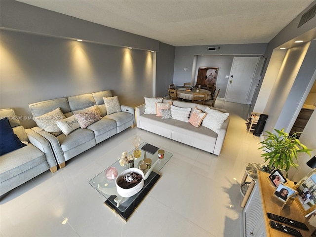 3850 Washington St Unit 704, Hollywood, FL 33021 - tiled living room with a textured ceiling