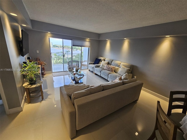 3850 Washington St Unit 704, Hollywood, FL 33021 - living area featuring a textured ceiling and baseboards