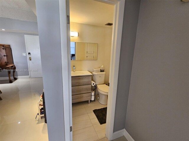 3850 Washington St Unit 704, Hollywood, FL 33021 - bathroom with tile patterned floors, toilet, vanity, and baseboards
