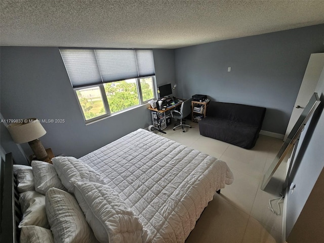 3850 Washington St Unit 704, Hollywood, FL 33021 - bedroom featuring a textured ceiling, tile patterned floors, and a desk