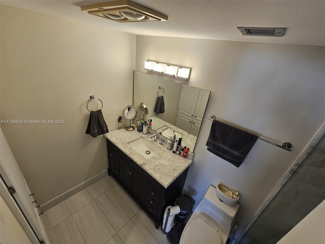 3850 Washington St Unit 704, Hollywood, FL 33021 - bathroom with vanity, toilet, tile patterned floors, and baseboards