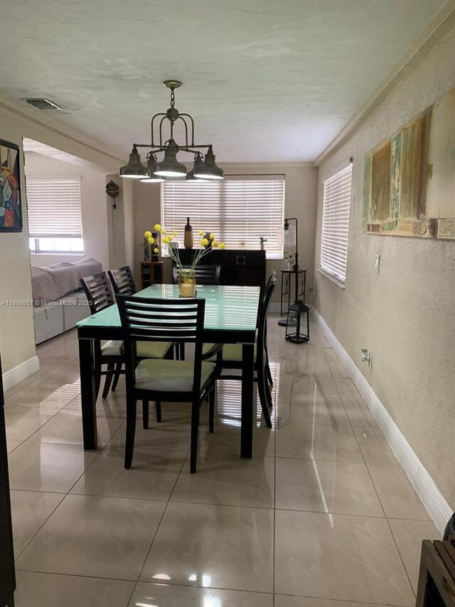 519 S 61st Ave, Hollywood, FL 33023 - dining space featuring baseboards, a chandelier, and light tile patterned flooring