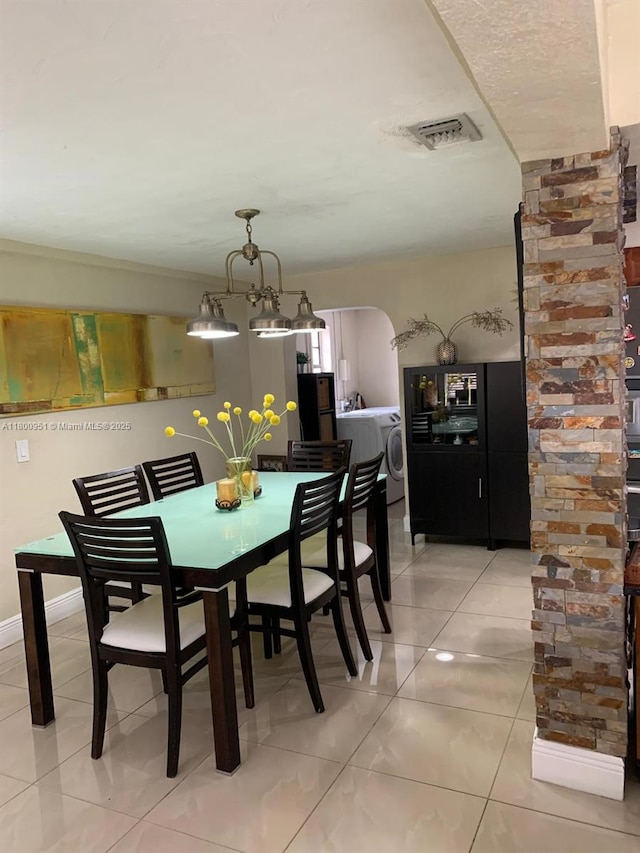 519 S 61st Ave, Hollywood, FL 33023 - dining space featuring washer / dryer, light tile patterned flooring, and arched walkways