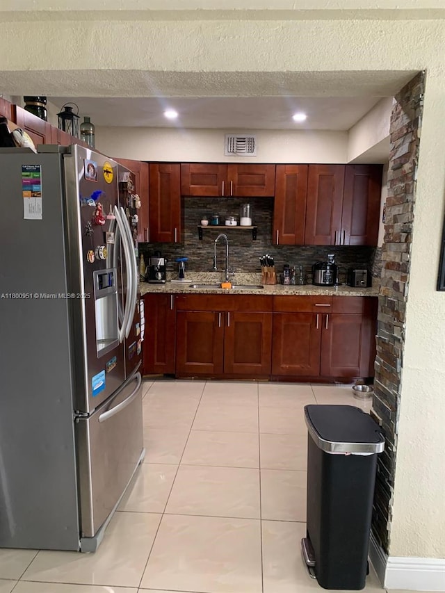 519 S 61st Ave, Hollywood, FL 33023 - kitchen with stainless steel fridge with ice dispenser, a sink, decorative backsplash, light tile patterned floors, and a textured ceiling
