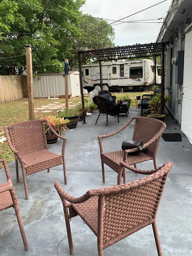 519 S 61st Ave, Hollywood, FL 33023 - view of patio featuring fence, an outbuilding, and a storage shed