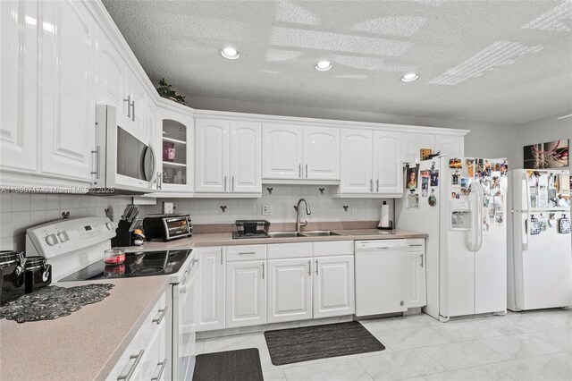 1621 NW 20th Ave Unit 203, Delray Beach, FL 33445 - kitchen featuring white appliances, white cabinetry, recessed lighting, tasteful backsplash, and light countertops