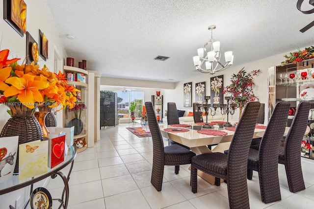 1621 NW 20th Ave Unit 203, Delray Beach, FL 33445 - dining space featuring a chandelier, a textured ceiling, and light tile patterned floors
