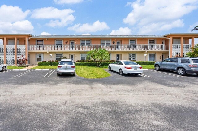 1621 NW 20th Ave Unit 203, Delray Beach, FL 33445 - view of building exterior featuring uncovered parking