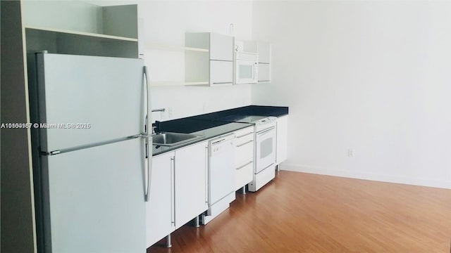 690 SW 1st Ct Unit 1227, Miami, FL 33130 - kitchen with white appliances, open shelves, dark wood finished floors, white cabinetry, and dark countertops