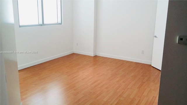 690 SW 1st Ct Unit 1227, Miami, FL 33130 - spare room featuring light wood-style floors and baseboards