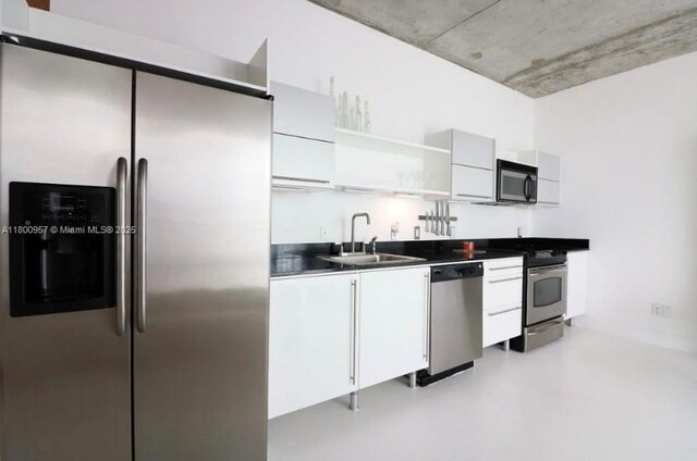 690 SW 1st Ct Unit 1227, Miami, FL 33130 - kitchen featuring appliances with stainless steel finishes, a sink, open shelves, and white cabinetry