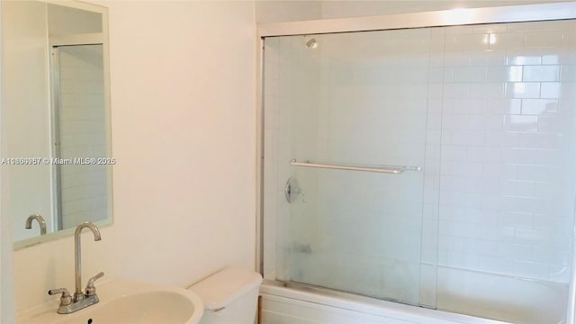 690 SW 1st Ct Unit 1227, Miami, FL 33130 - bathroom with a sink, toilet, and bath / shower combo with glass door