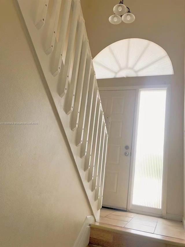 3734 NW 107th Way, Sunrise, FL 33351 - entrance foyer with a chandelier, stairway, baseboards, and light tile patterned flooring