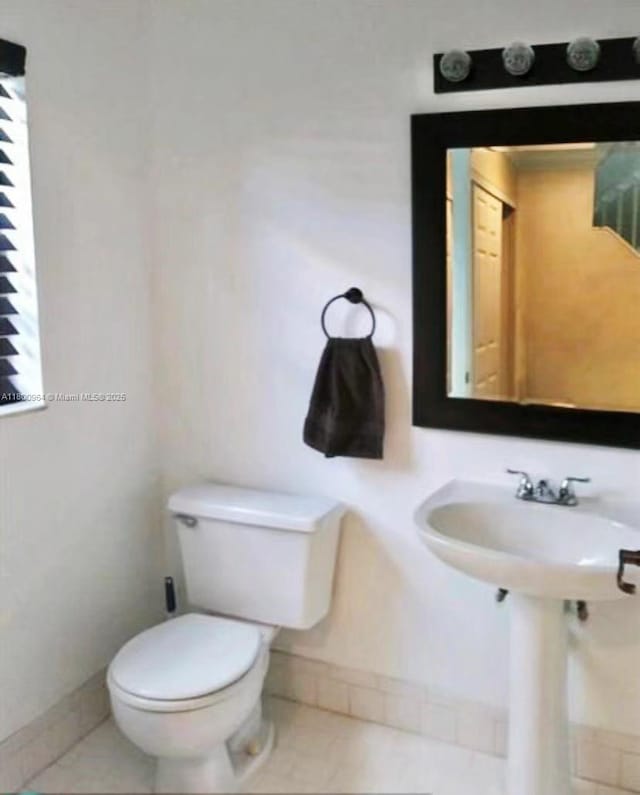 3734 NW 107th Way, Sunrise, FL 33351 - half bath featuring toilet, baseboards, tile patterned floors, and a sink