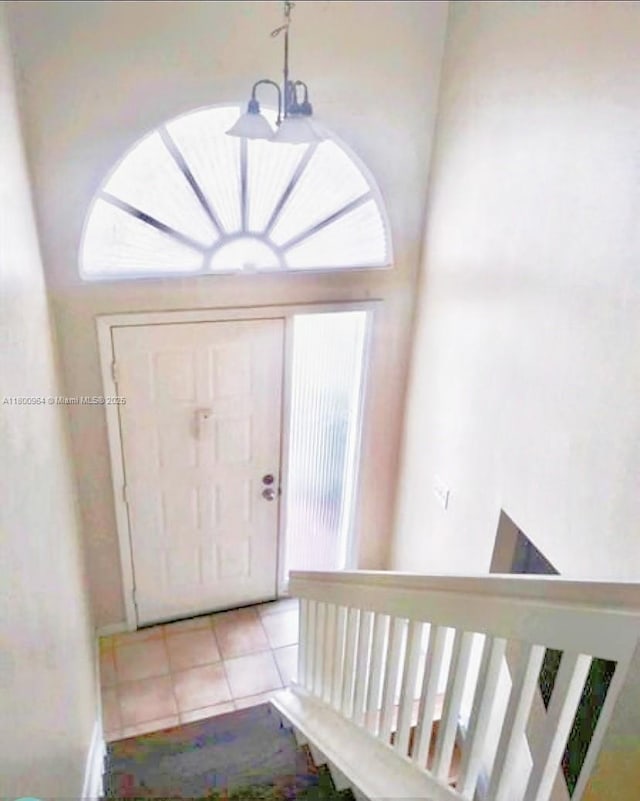 3734 NW 107th Way, Sunrise, FL 33351 - foyer entrance with a chandelier and light tile patterned flooring