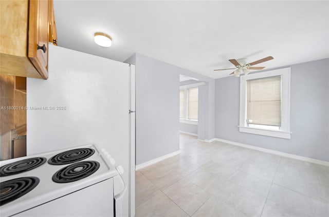 1621 Van Buren St, Hollywood, FL 33020 - kitchen featuring white range with electric stovetop, ceiling fan, baseboards, and light tile patterned floors