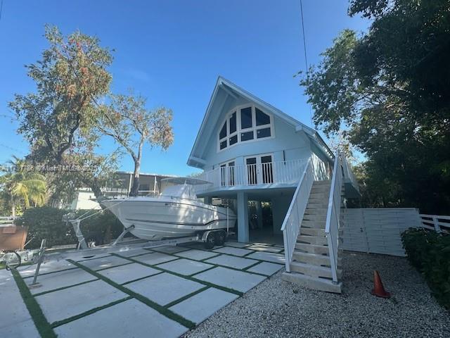 back of house featuring stairs
