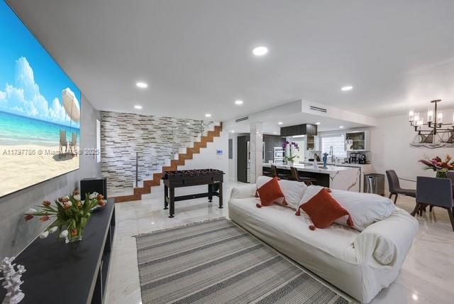 living area with a chandelier and recessed lighting