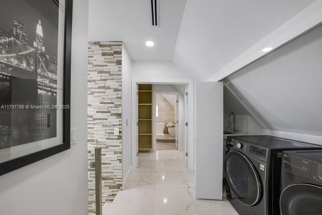 laundry area featuring separate washer and dryer, marble finish flooring, and recessed lighting