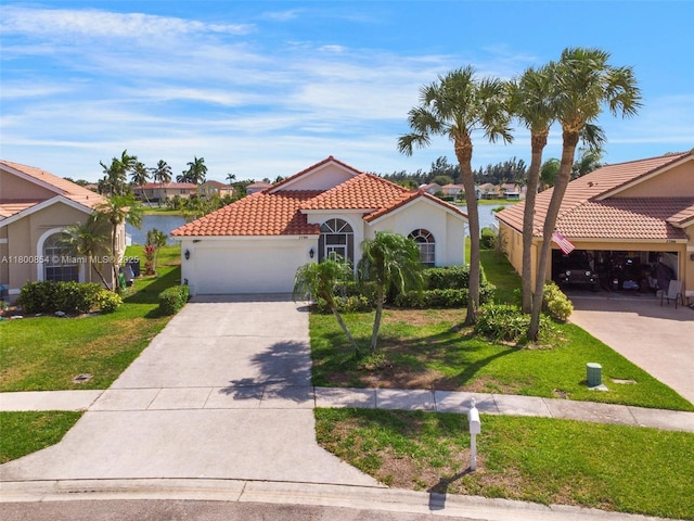 mediterranean / spanish-style home with stucco siding, a front yard, a garage, a tiled roof, and driveway