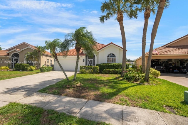 mediterranean / spanish home with a tiled roof, driveway, an attached garage, stucco siding, and a front yard