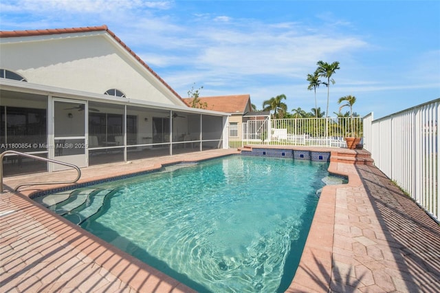 view of swimming pool with a ceiling fan, a sunroom, a fenced backyard, and a patio