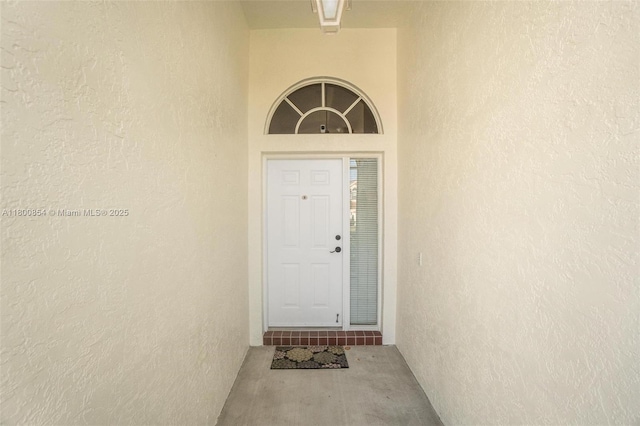 view of exterior entry with stucco siding